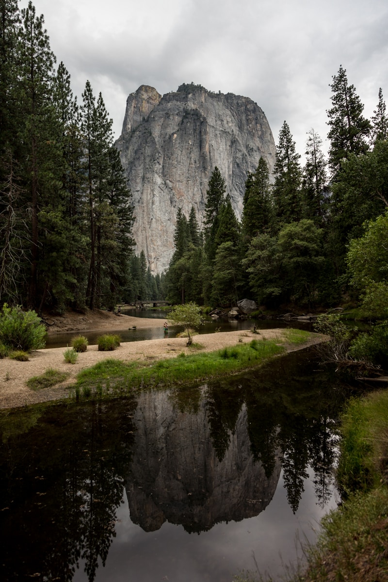 body of water near mountain at daytime