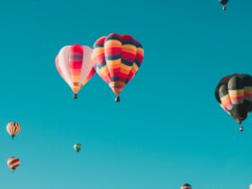 assorted hot air balloons flying at high altitude during daytime