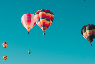 assorted hot air balloons flying at high altitude during daytime